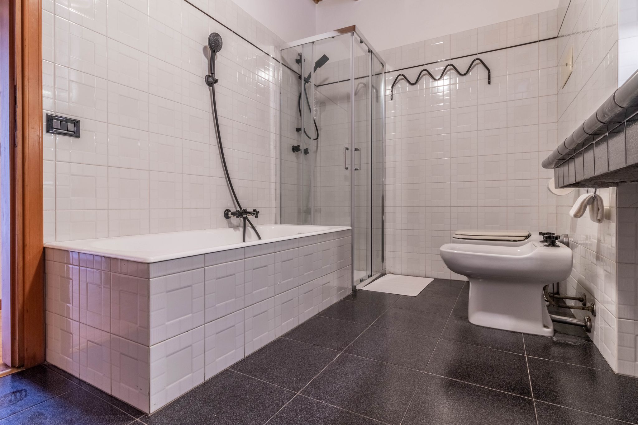 Full bathroom with bathtub, shower enclosure, and bidet